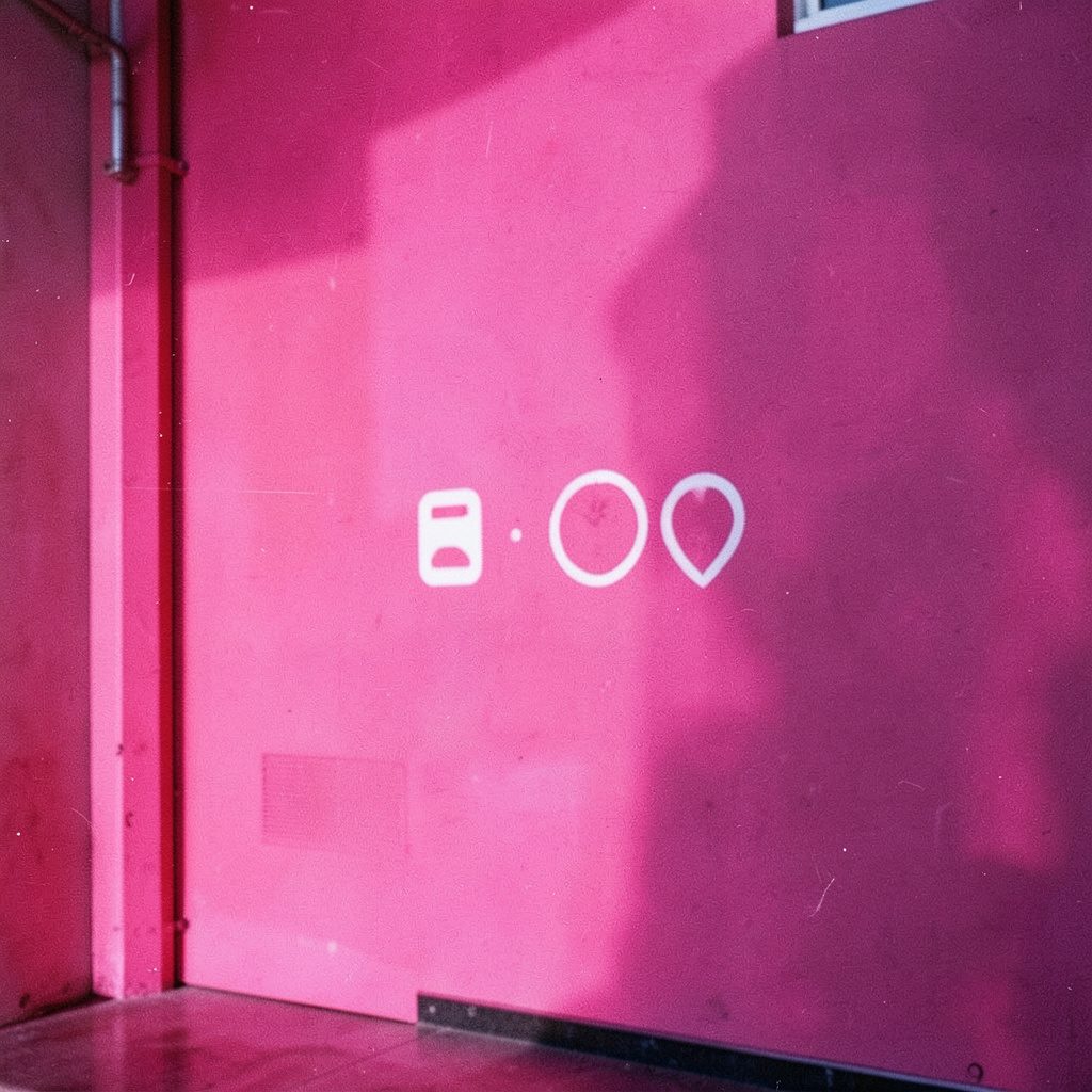 A bold square logo-style graphic with strong geometric shapes in black, white and vivid magenta, flat and modern